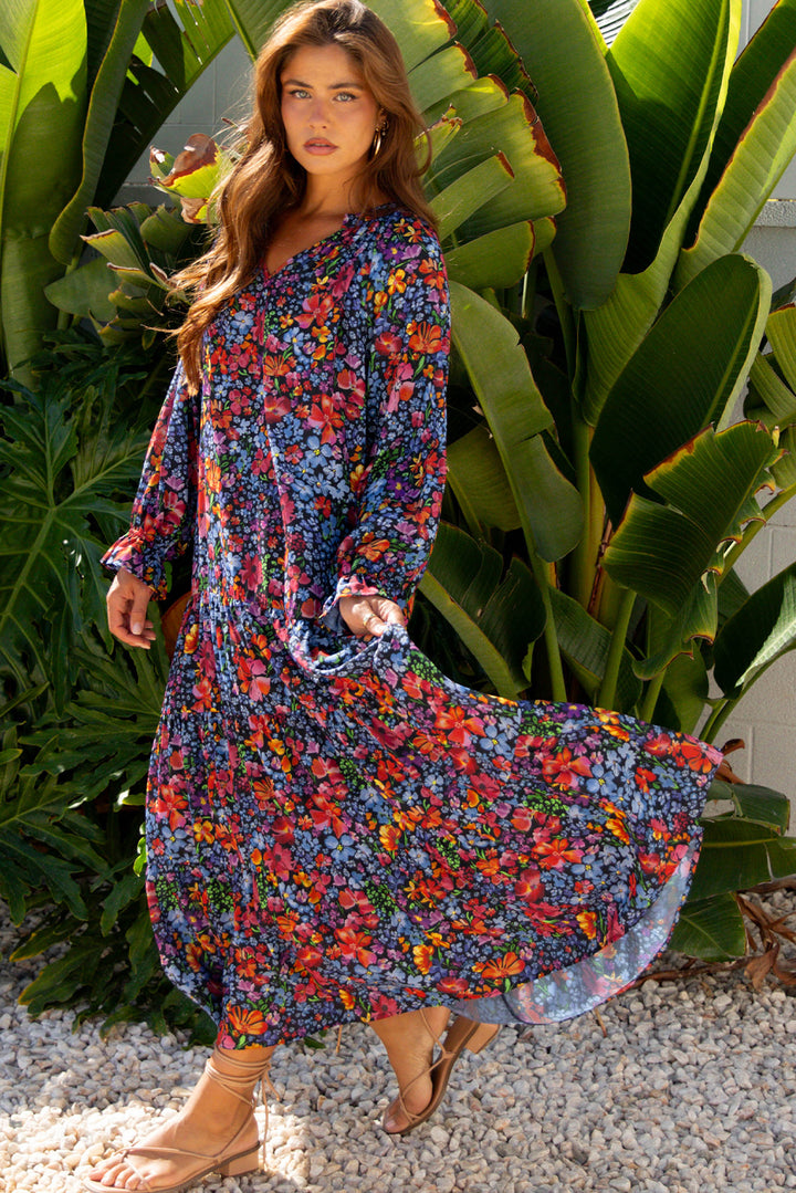 Vestido largo fluido con cuello en V, manga larga y estampado floral azul con borlas y lazo