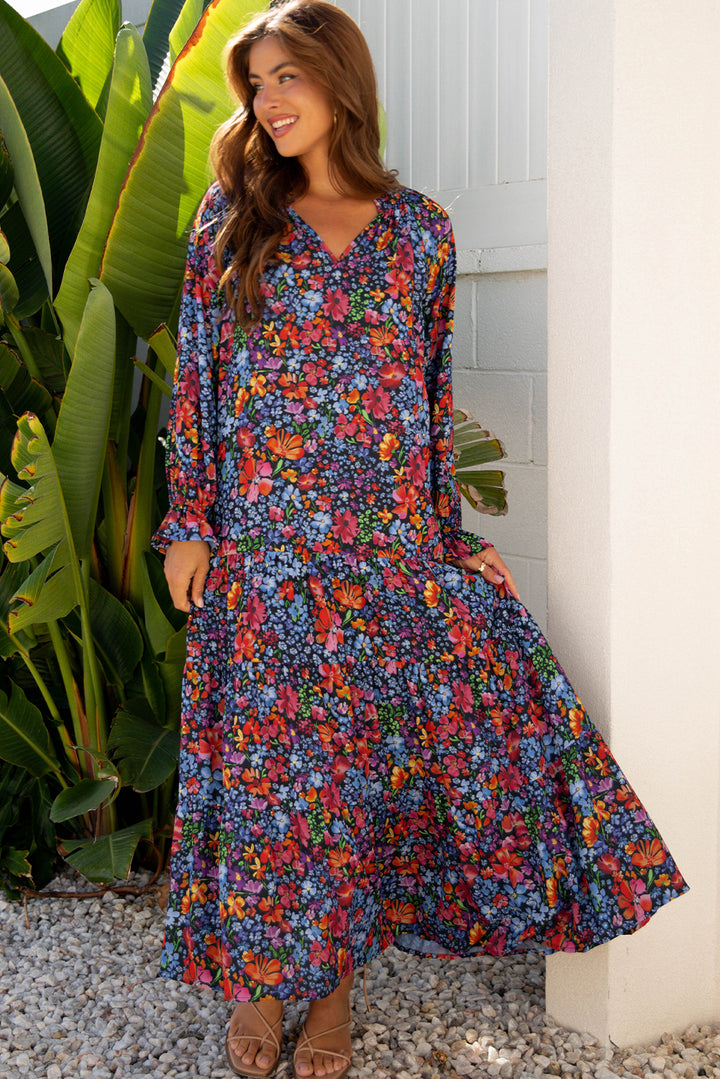 Vestido largo fluido con cuello en V, manga larga y estampado floral azul con borlas y lazo