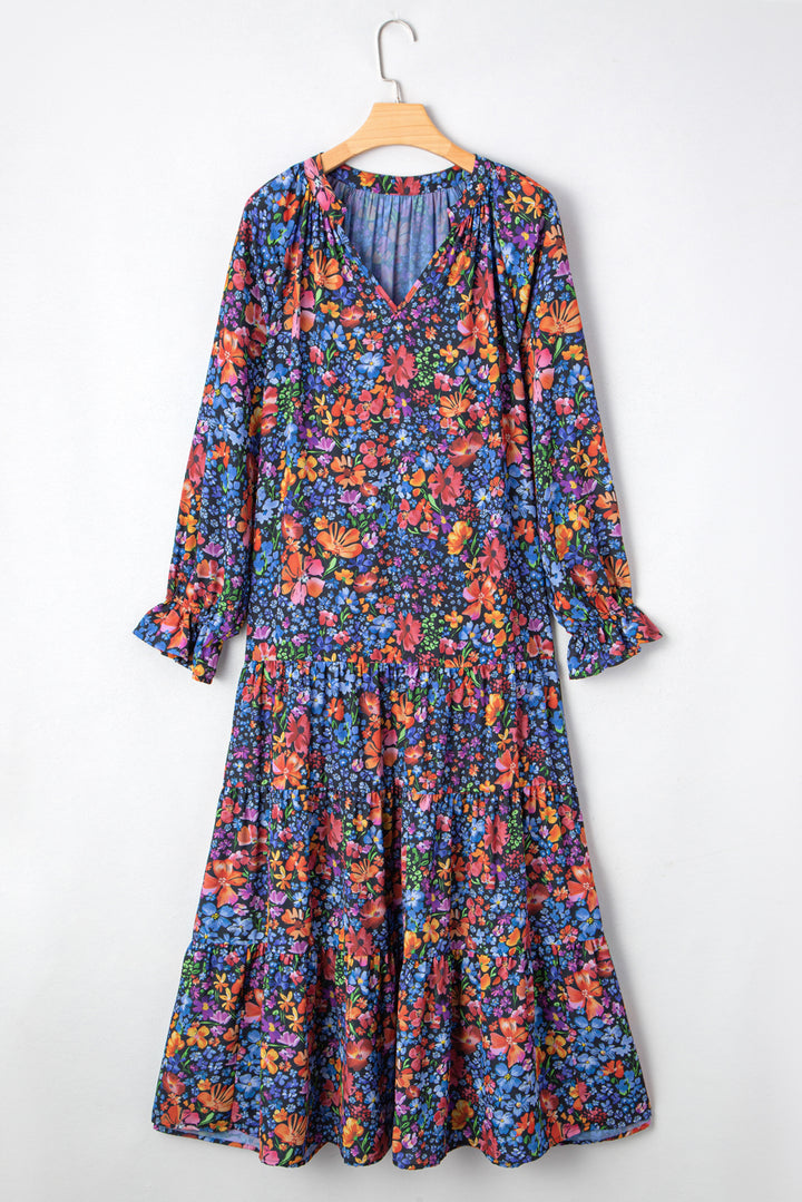 Vestido largo fluido con cuello en V, manga larga y estampado floral azul con borlas y lazo
